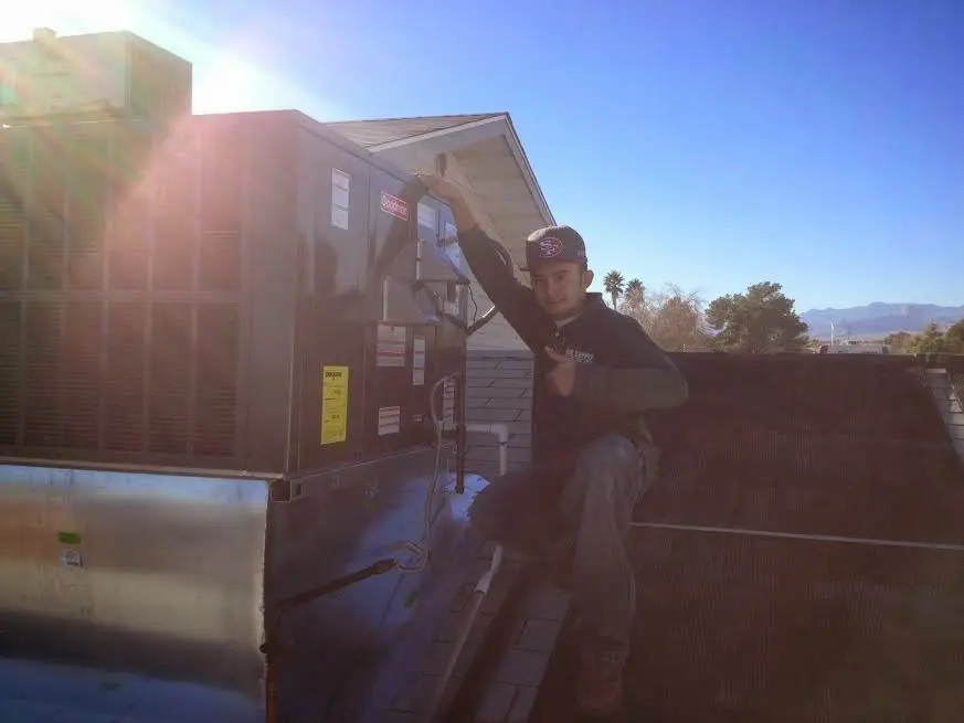 HVAC technician performing HVAC Inspection on a rooftop unit in Strasburg